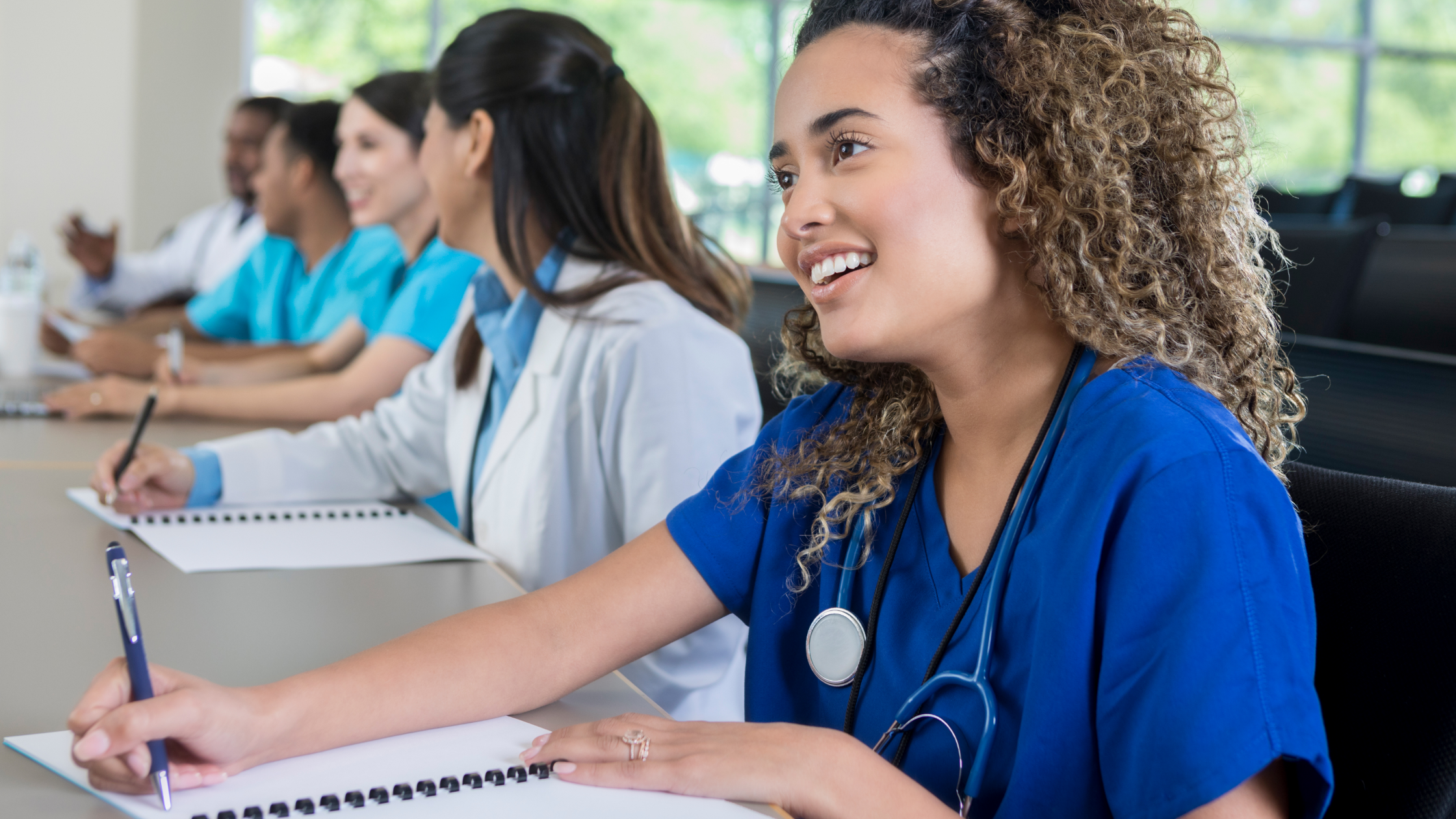 Nursing students smiling and studying together.