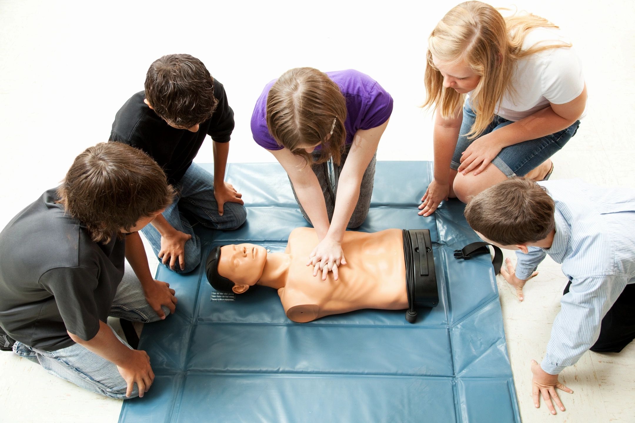 Adult students practicing CPR on a CPR dummy. 